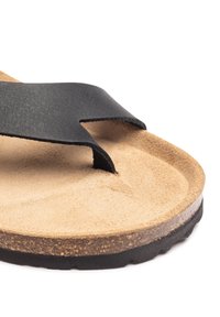 Black soft faux leather strap over tan cork footbed with a textured surface, rounded toe post, and dark rubber sole.