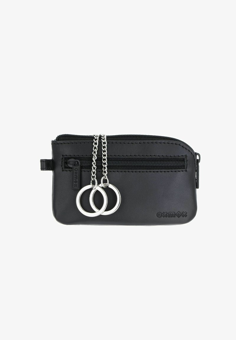 Pochette en cuir noir zippée avec une poche avant zippée, deux porte-clés argentés sur chaînes, et logo « oxmox » embossé en bas à droite.