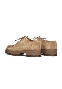 Beige suede lace-up shoes with a rounded toe, contrasting brown rubber sole featuring grooves, and minimal stitching detail on the upper.
