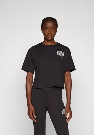 Black cropped t-shirt made of cotton with short sleeves and round neck. Features white embroidered "PUMA sports club" logo on the chest.