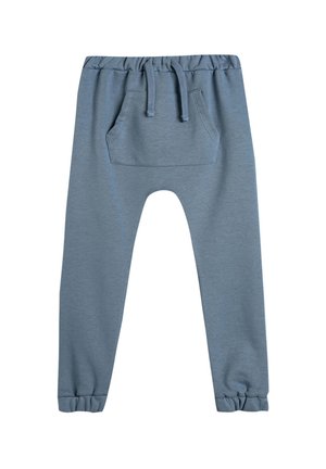 Pantalones de chándal azules de algodón con una cintura elástica, cordón y un bolsillo trasero. Tobillos acampanados con una textura suave y lisa.