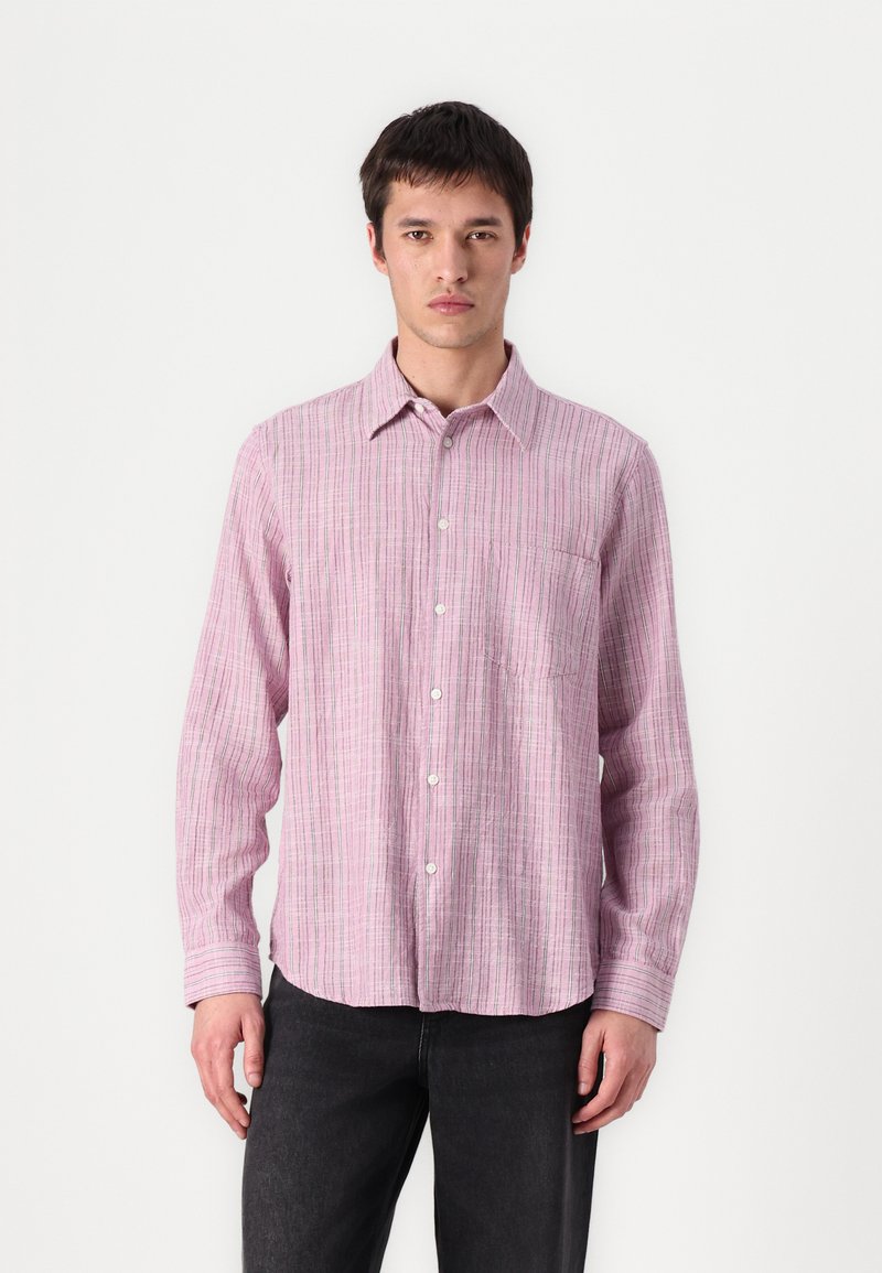 Light pink button-up shirt with thin vertical stripes in darker shades. Features a chest pocket and relaxed fit. Fabric appears textured.
