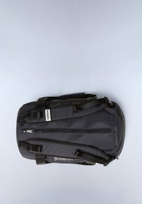 Black nylon duffel bag with adjustable straps, multiple zipped pockets, and a solid texture. Brand label visible on the front.