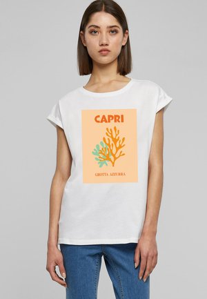 White cotton t-shirt with rolled short sleeves, featuring a coral design in orange and teal against an orange background; "CAPRI" text included.