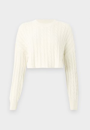 Cream cable-knit cropped sweater with long sleeves and ribbed crewneck. Textured pattern throughout and fitted cuffs.