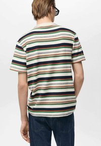 T-shirt à manches courtes à rayures, présentant des rayures horizontales en marine, vert et rouge sur un fond crème. Tissu en coton doux et texturé.