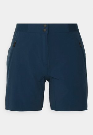 Un short bleu marine en matériau léger, doté d'une poche zippée, d'une taille plate et de deux fermetures à bouton à l'avant.