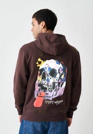 Brauner Hoodie mit einem farbenfrohen Totenkopf-Motiv auf der Rückseite, Akzente in Gelb, Pink und Blau. Aus Baumwollmaterial mit legerem Schnitt.