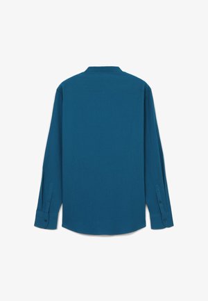 Langärmeliges Hemd in einem einfarbigen, tiefen Petrolton mit lockerem Schnitt, Knopfmanschetten und klassischem Kragen. Hergestellt aus einem strukturierten Stoff.