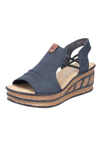 Navy wedge sandals with open toe, made of soft material. Features a cork heel and tan accents, with elastic straps for a secure fit.