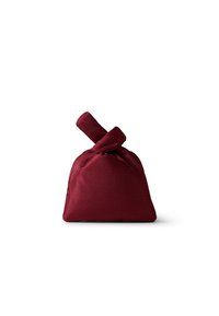 Burgundy fabric bag with a knot handle, featuring a textured appearance and a unique triangular shape. Designed for compact storage.