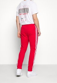 adidas Originals Teplákové kalhoty - red