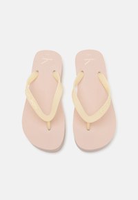 Calvin Klein flip-flops with a soft pink footbed and pale yellow straps. Features embossed logo on the footbed and strap.