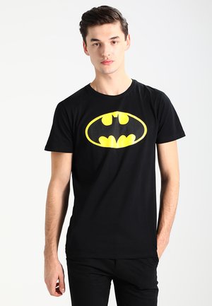 Black cotton t-shirt featuring a large yellow Batman logo on the front. Short sleeves and a round neckline, with a smooth texture.