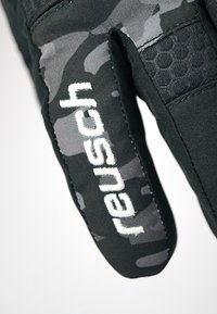 Black gloves with camo pattern accents. “Reusch” logo in white on the side. Textured grip areas and sleek design, suitable for winter sports.