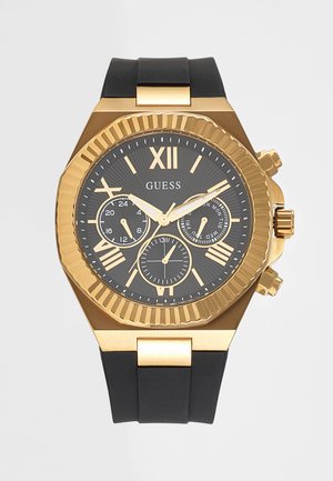 Мъжки часовник Guess с черен циферблат, златист обков, римски цифри, три подциферблата и черна гумена каишка.