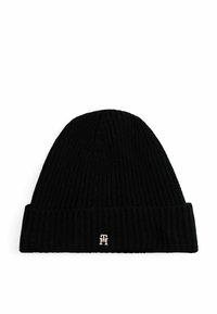 Black knit beanie hat with a ribbed texture. Features a folded cuff and a small metallic logo accent in gold on the front.