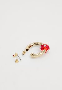 Gold hoop earrings featuring a red and white polka dot glass bead, with additional red stud earring components included.