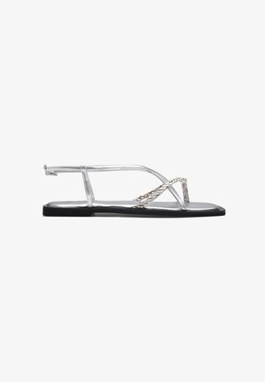 Zilveren platte sandalen met metallic straps en gevlochten details. Heeft een minimalistisch ontwerp en een platte zwarte zool voor extra comfort.