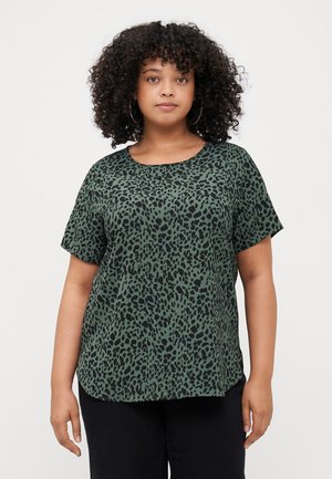 Short-sleeve green top with a black leopard print pattern, round neckline, slightly curved hem, and soft, lightweight fabric.