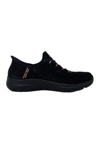 Black Skechers slip-on shoes with a textured croc pattern, pink accents on laces, and a flexible rubber sole for comfort.