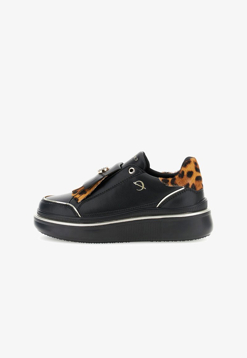 Black sneaker with a glossy finish, leopard print accent, silver hardware, and a thick black sole. Slip-on design with decorative detail.