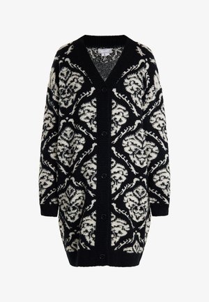 Fekete és krém színű mintás kardigán, V nyakkivágással, hosszú ujjakkal és gombokkal az elején. Texturált kötésű és virágmintás kialakítás jellemzi.