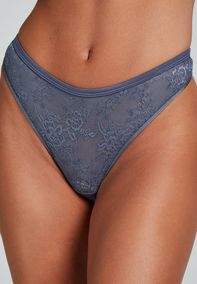 Bikini trosor med spetsdetaljer i en mjuk grå färg. Har blommönster, en slät midja och en sömlös design för komfort.