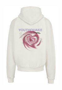 Balts kapuce ar lielu lavandas krāsas "YOUTHAQUAKE" drukājumu un rozā spirāles grafiku aizmugurē. Mīksta auduma un brīva piegriezuma, ar kapuci.