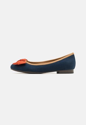 Navy blue suede ballet flat with a rounded toe and a rust-colored bow accent. Features a tan interior and a low brown heel.
