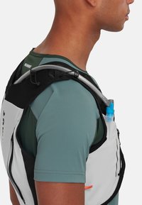 Waterproof hydration vest in white and black, featuring adjustable straps and a blue hydration bladder tube on the back, slim fit design.