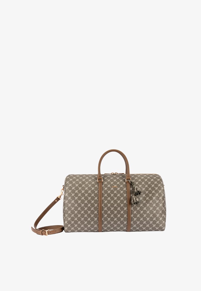 Grüne gemusterte Reisetasche mit braunen Ledergriffen und verstellbarem Gurt. Mit dekorativen Quastenakzenten und einem Reißverschlussverschluss.