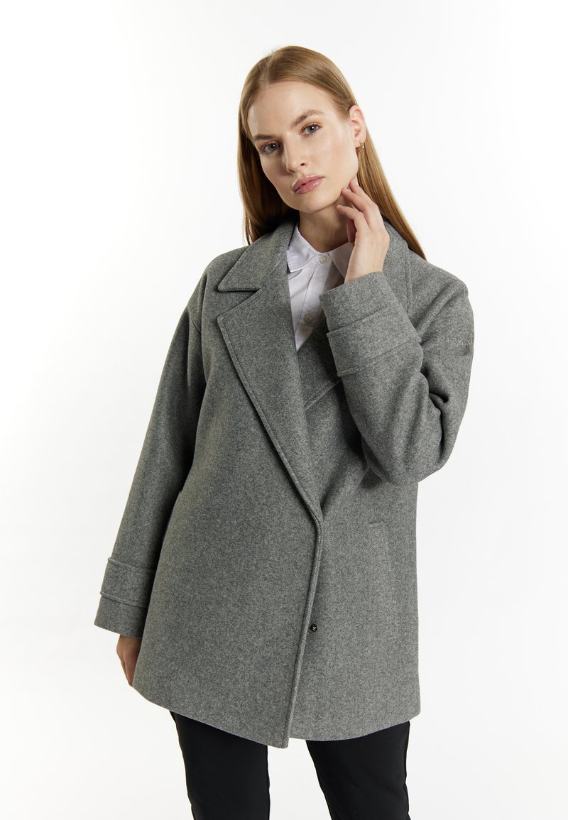 Grijze wolmix jas met een dubbelzijdig ontwerp, brede revers en een relaxte pasvorm. De mouwen zijn iets oversized en met een manchet.