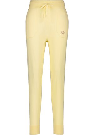 Yellow knit joggers with a drawstring waist, two front pockets, and a small heart embroidery on the left pocket.