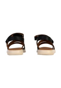 Sandali in pelle nera con una soletta color cuoio, dotati di fascette incrociate e una suola in gomma bianca testurizzata.