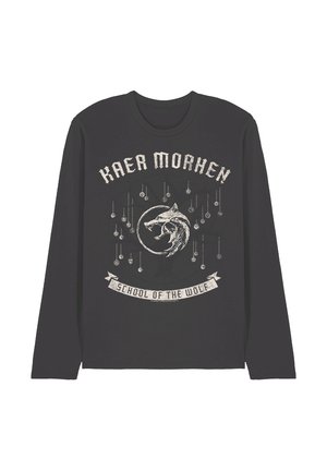 Black long-sleeve shirt with distressed white text "Kaer Morhen" above a wolf emblem and "School of the Wolf" on a banner beneath it.