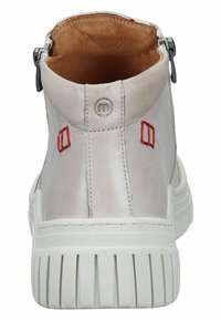 White leather ankle boot with a textured surface, featuring red stitching accents and a zipper detail on the side. Thick white sole.
