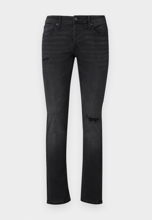 Zwarte denim jeans met een slim fit, met zichtbare verfrepatronen op de knieën, vijf zakken en een standaard knoop- en ritssluiting.
