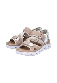 Sandales avec un design beige et blanc, dotées de sangles réglables, d'une semelle intérieure douce et d'une semelle blanche légère et texturée.