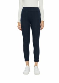 Leggings blu navy con un design aderente, cintura elastica e un sottile motivo testurizzato, abbinate a sneakers bianche.