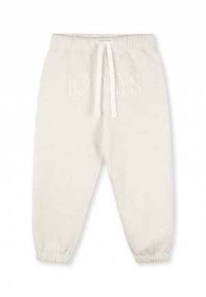 Pantaloni sportivi grigi chiari con cintura elastica, lacci e polsini elastici. Presentano testo bianco che recita "10 GIORNI" nella parte anteriore.