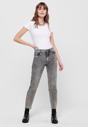 Gray denim jeans with a slightly faded finish, high waist, five pockets, and frayed hems, paired with a fitted white t-shirt and black ankle boots.