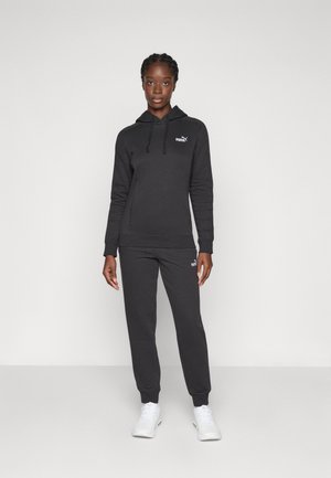 Black hoodie and sweatpants set in soft fabric, featuring a small white logo on the chest and left leg, with ribbed cuffs and hem.
