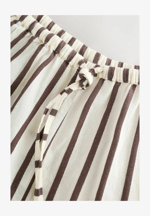 Material cu dungi, având o talie elastică și un șnur de ajustare legat. Culorile includ crem și maro, cu dungi verticale și o textură moale.