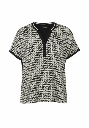 Blouse à manches courtes avec motif circulaire noir et blanc, bordure noire sur les manches et encolure en V avec patte de boutonnage partielle.