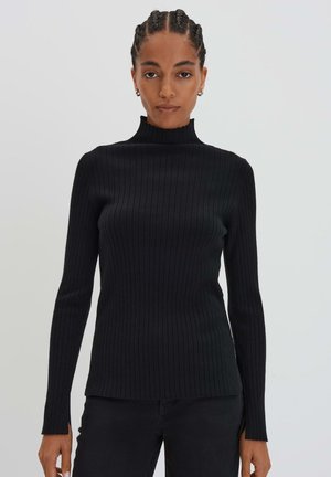 Schwarzer gerippter Rollkragenpullover mit langen Ärmeln, hergestellt aus einem eng anliegenden Strickmaterial. Verfügt über eine figurbetonte Silhouette und ein strukturiertes Design.