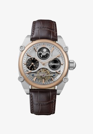 Automatische horloge met een roestvrijstalen en roségouden kast, een bruine krokodillenleren band, een skeleton wijzerplaat en zon/maan fase indicatoren.