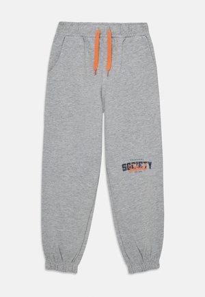 Hallid hallid spordipüksid elastse vöökohaga ja oranžide paeltega. Omab küljetaskuid ning sinise ja oranži trükitud logo reie peal.