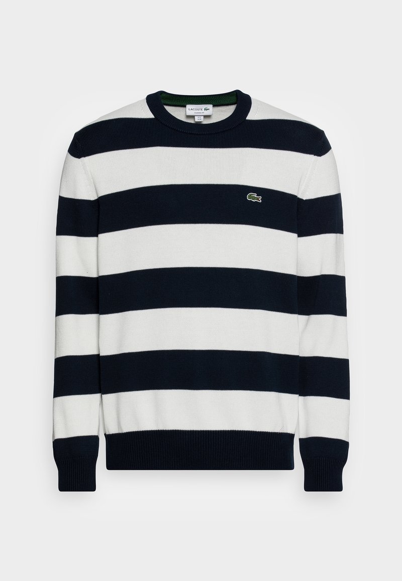 Pull en tricot rayé bleu marine et blanc avec un col ras du cou, des poignets côtelés et un petit logo vert Lacoste sur la poitrine gauche.