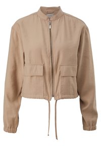 Beige, cropped bomberjakke lavet af letvægtsstof, med en frontlynlås, to brystlommer og en snor i kanten.